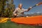 Senior woman canoeing on summer day