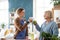 Senior woman with caregiver or healthcare worker indoors, drinking healthy smoothie.