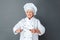 Senior woman chef studio standing on gray sharpening knives concentrated joyful