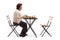 Senior woman with a chessboard at a table looking at an empty chair