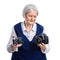 Senior woman choosing between old analogue camera and modern digital one