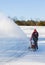 Senior woman clearing drive with snowblower