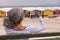 Senior woman clicking photo with mobile phone while sitting on promenade bench