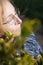 Senior woman with closed eyes enjoys outside with face towards the sun