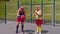 Senior woman coach teaching grandfather with basketball dribbling exercise with ball on playground