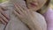 Senior woman condolencing to man about disease or loss, support, care, closeup