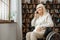 Senior woman with disability recovery at home wheelchair phone call