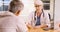 Senior woman doctor talking to elderly patient in the office