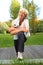 Senior woman doing sport with towel over neck