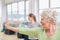 Senior woman doing stretching exercise at yoga class