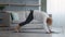 Senior Woman Doing Yoga Dog Pose Exercising At Home, Side-View