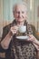 Senior woman drinking coffee alone