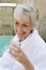 Senior Woman Drinking Lime Water Outdoors