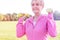 Senior woman with dumbbells exercising in park