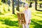 Senior woman with easel drawing outdoors