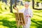 Senior woman with easel painting outdoors