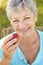 Senior woman eating apple