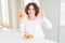 Senior woman eating sweet belgian waffle doing ok sign with fingers, excellent symbol