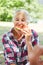 Senior woman eats a watermelon in the park