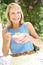 Senior Woman Enjoying Bowl Of Breakfast Cereal