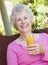 Senior woman enjoying glass of juice