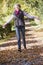 Senior woman enjoying walk through woods