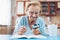 Senior woman enjoys solving a crossword puzzle