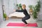 Senior woman exercising home, the concept of a healthy lifestyle, fitness and yoga