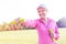 Senior woman exercising with weights in park