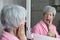 Senior woman experimenting pain while washing her teeth