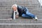 Senior woman falling down stone steps outdoors