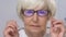Senior woman fitting eye glasses, incorrect optical device, vision problems