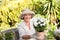 Senior woman with flowers in her garden