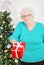 Senior woman giving christmas present