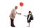 Senior woman giving red balloon to a schoolgirl