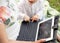 Senior woman in glasses and her grandchild using laptop in the park