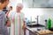 Senior woman/grandmother cooking in a modern kitchen with her grand-daughter