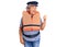 Senior woman with gray hair wearing nautical lifejacket pointing thumb up to the side smiling happy with open mouth