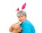Senior woman greedily takes away Easter basket  isolated