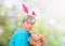 Senior woman greedily takes away Easter basket outdoor