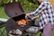 Senior woman grilling chicken meat for preparing eat in camping, elderly doing activity recreation and leisure picnic.