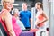 Senior woman in group with pregnant woman working out at the gym