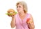 Senior woman with hamburger and apple