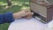 Senior woman hand turning knob on vintage radio in backyard