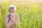 Senior woman with handkerchief in the grass