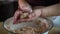 Senior woman hands making balls from minced meat closeup