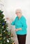 Senior woman hanging christmas ornament