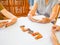 A senior woman is happily playing a domino game with her family in retirement