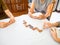 A senior woman is happily playing a domino game with her family in retirement