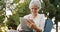 Senior woman happily surfing the web on tablet